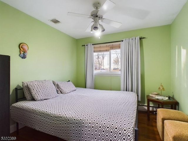 bedroom with ceiling fan and dark hardwood / wood-style flooring