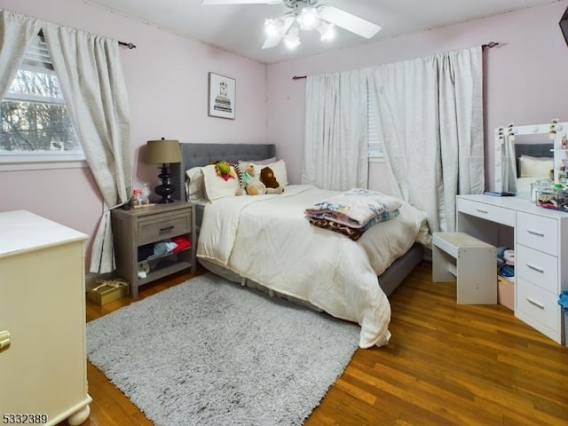 bedroom featuring ceiling fan and dark wood-type flooring