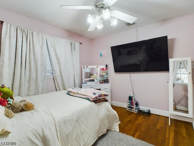 bedroom with ceiling fan and dark wood-type flooring