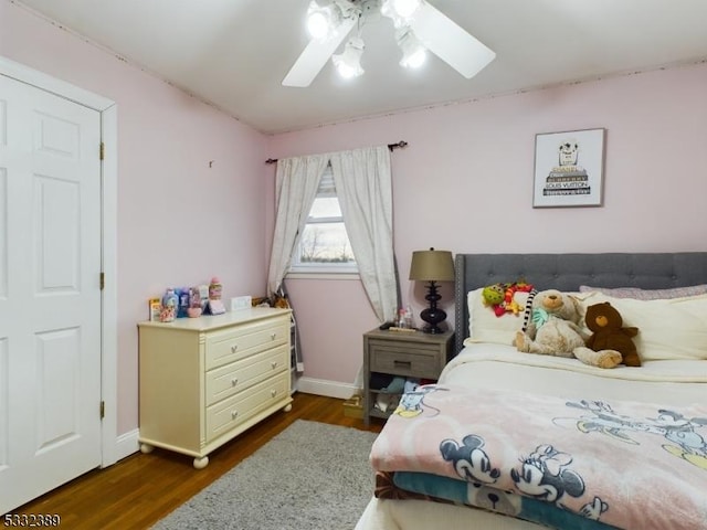 bedroom with ceiling fan and dark wood-type flooring