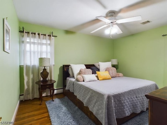 bedroom with ceiling fan and dark wood-type flooring