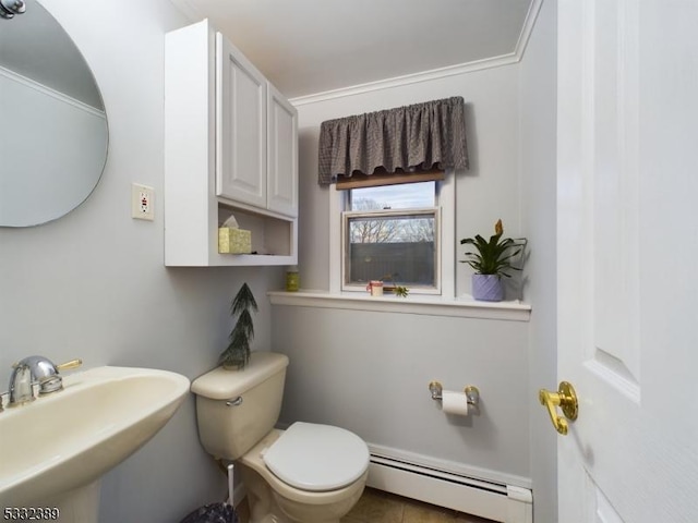 bathroom with toilet, sink, and baseboard heating