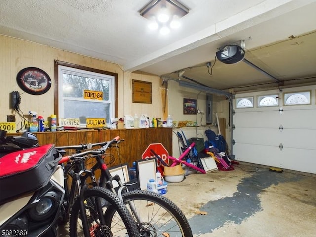 garage featuring electric panel and a garage door opener