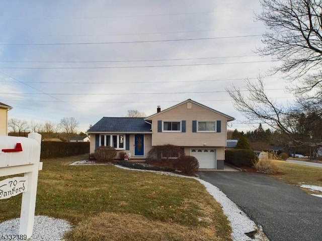 tri-level home with a front yard and a garage