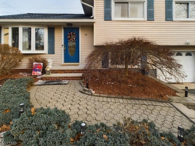 view of exterior entry featuring a garage