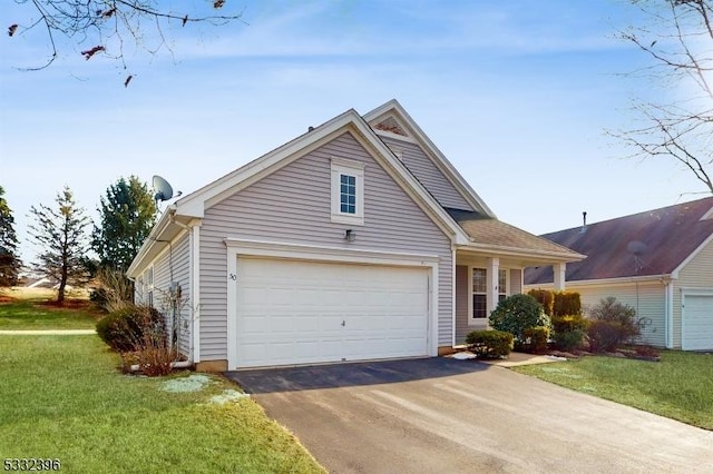 view of front of home with a garage and a front lawn