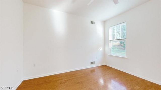 unfurnished room with hardwood / wood-style flooring and plenty of natural light