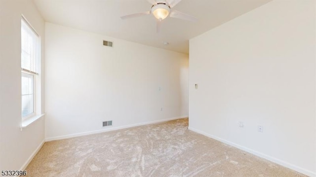 unfurnished room featuring light carpet and ceiling fan