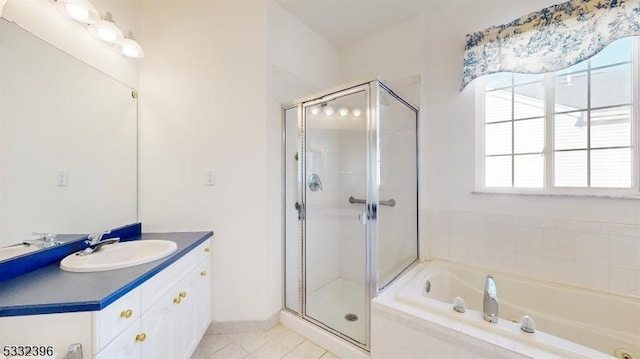 bathroom featuring tile patterned flooring, shower with separate bathtub, and vanity