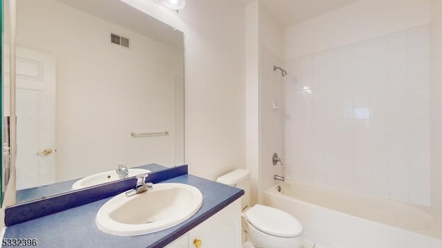 full bathroom with tiled shower / bath combo, vanity, and toilet