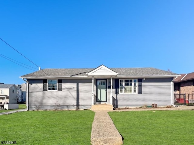 ranch-style home featuring a front lawn