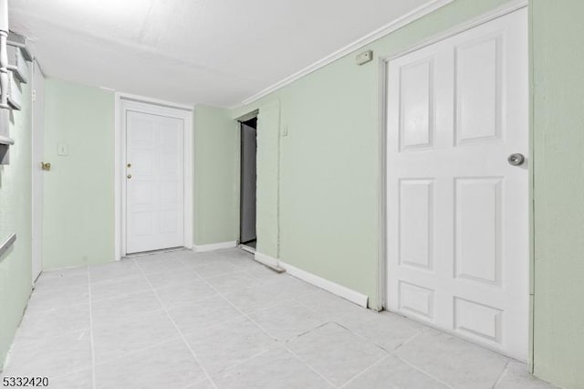 unfurnished room with crown molding