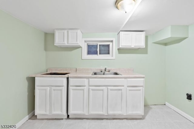 laundry room with sink and light tile patterned floors