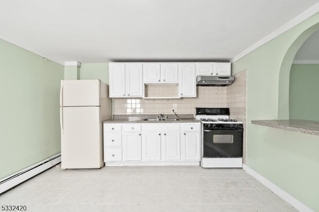 kitchen featuring gas range, tasteful backsplash, baseboard heating, white cabinets, and white refrigerator