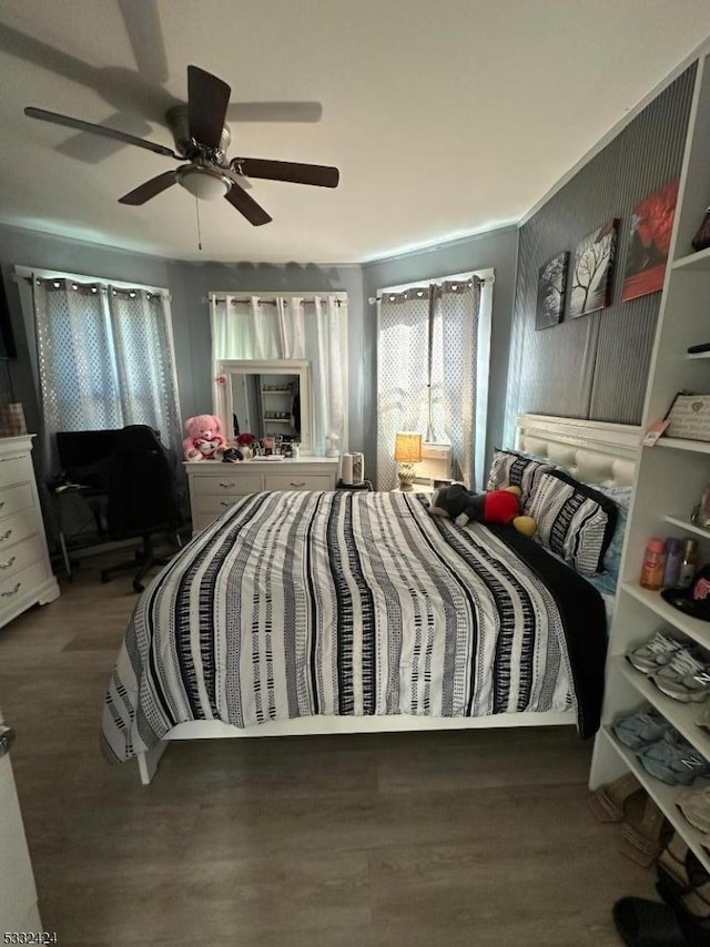 bedroom with ceiling fan and dark hardwood / wood-style floors