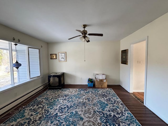 living area featuring ceiling fan, dark wood-type flooring, and a baseboard radiator