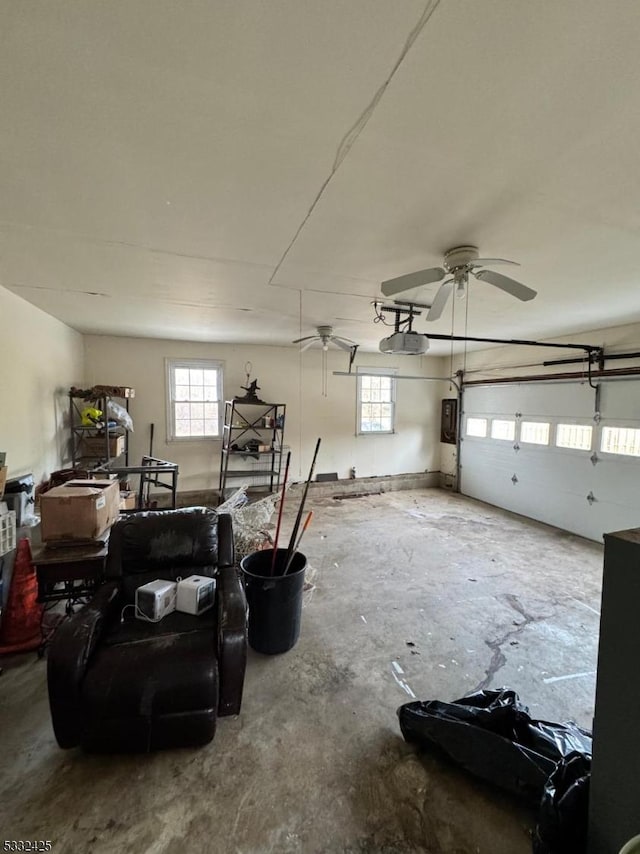 garage with electric panel, ceiling fan, and a garage door opener