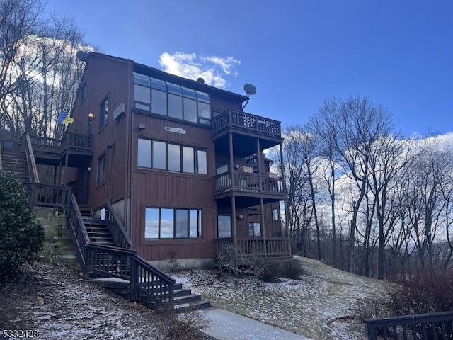 rear view of property featuring a balcony