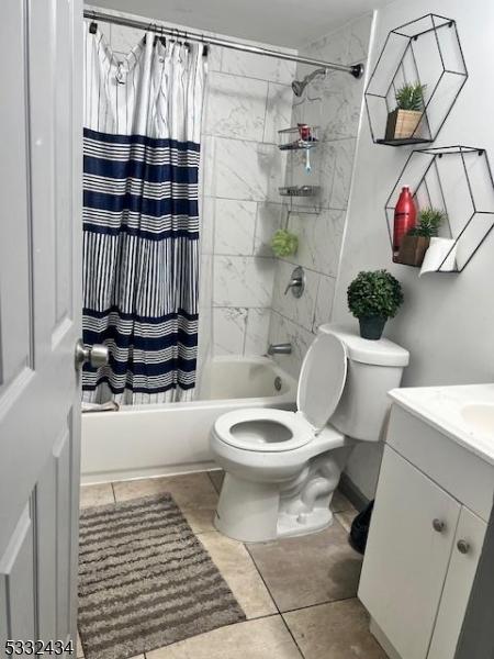 full bathroom featuring toilet, shower / tub combo, tile patterned flooring, and vanity