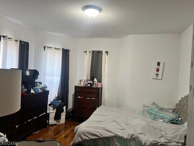 bedroom featuring dark hardwood / wood-style flooring