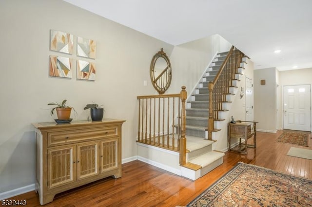 stairway featuring wood-type flooring