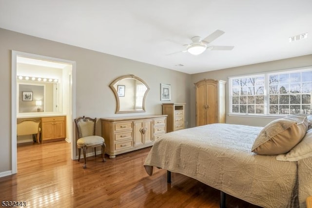 bedroom featuring ensuite bathroom, ceiling fan, and light hardwood / wood-style floors