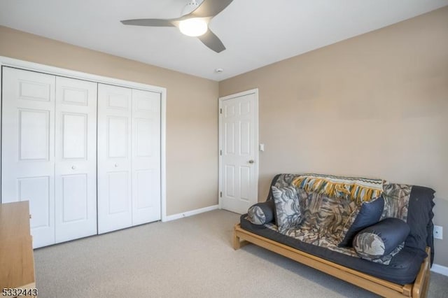 sitting room with ceiling fan and carpet