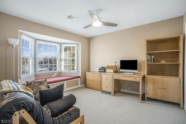 carpeted office with ceiling fan