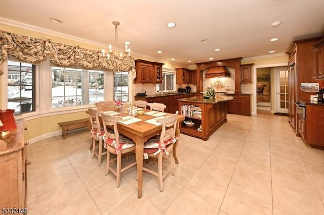 dining area featuring light tile patterned floors, a notable chandelier, and ornamental molding