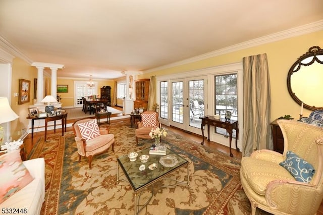 living room with decorative columns, crown molding, and french doors