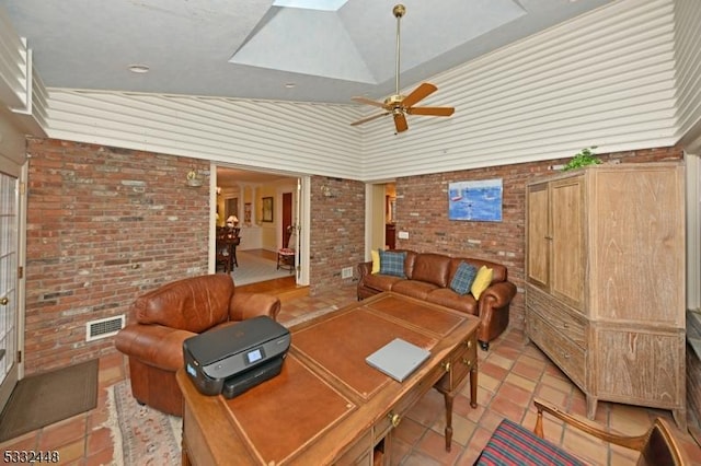 tiled office featuring ceiling fan, lofted ceiling, and brick wall