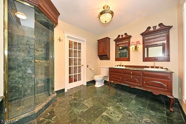 bathroom featuring vanity, an enclosed shower, and toilet