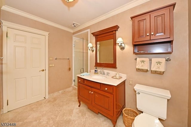 bathroom with toilet, vanity, crown molding, and a shower with shower door