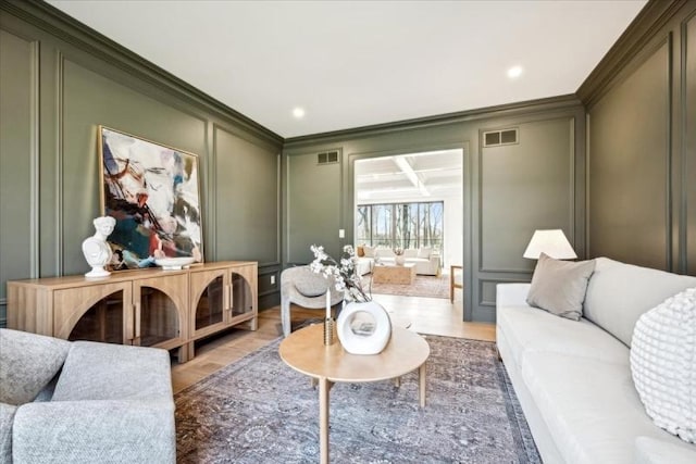 interior space featuring light wood-type flooring and crown molding