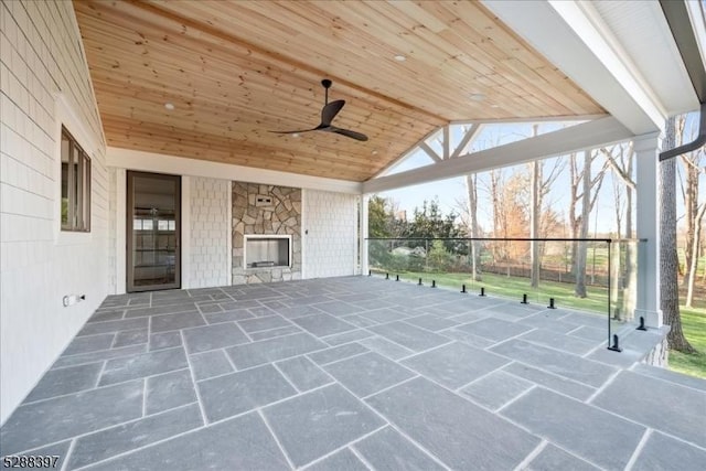 unfurnished sunroom featuring ceiling fan, wood ceiling, and lofted ceiling