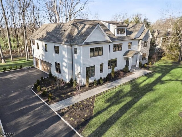 view of front facade featuring a garage and a front lawn