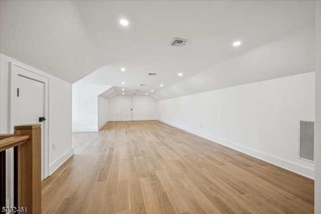 bonus room with light hardwood / wood-style floors and lofted ceiling