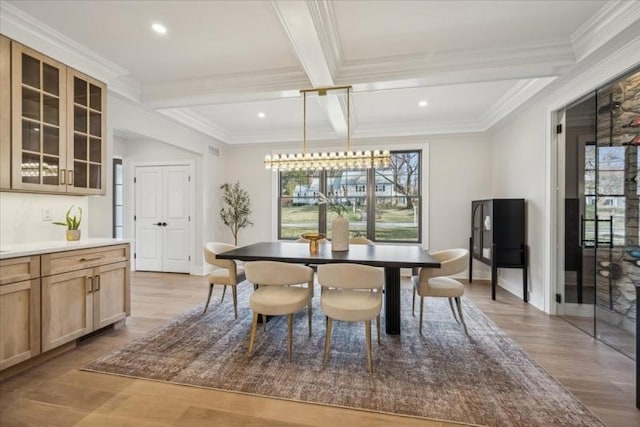 dining area with beam ceiling, light hardwood / wood-style flooring, coffered ceiling, and crown molding