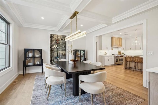 dining space featuring crown molding, beamed ceiling, light hardwood / wood-style floors, and coffered ceiling