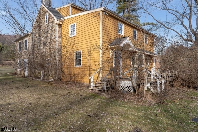 view of home's exterior with a lawn