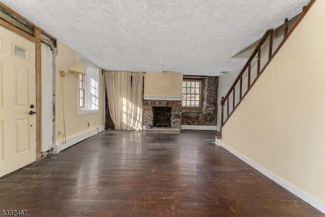 unfurnished living room with a baseboard radiator, a textured ceiling, and dark hardwood / wood-style floors