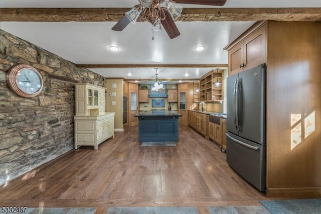 kitchen with decorative light fixtures, stainless steel refrigerator, dark hardwood / wood-style floors, a kitchen island, and beam ceiling