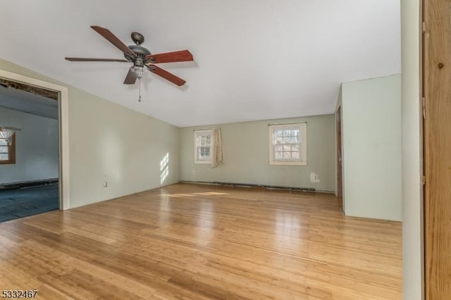 unfurnished living room featuring ceiling fan and light hardwood / wood-style flooring