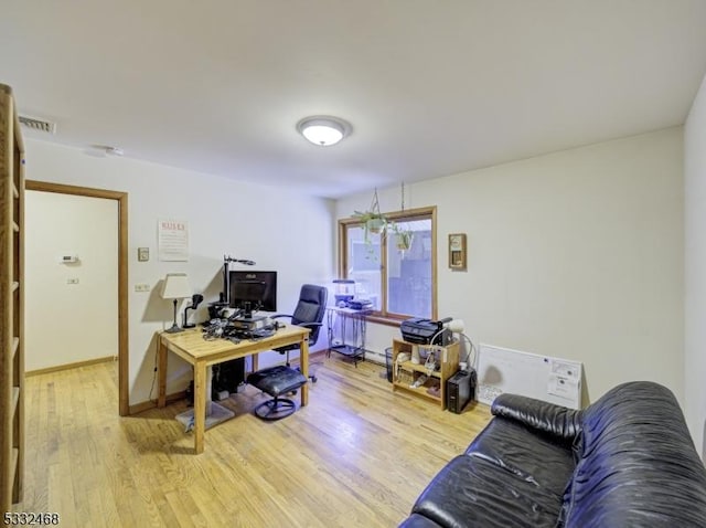 home office featuring light wood finished floors and baseboards