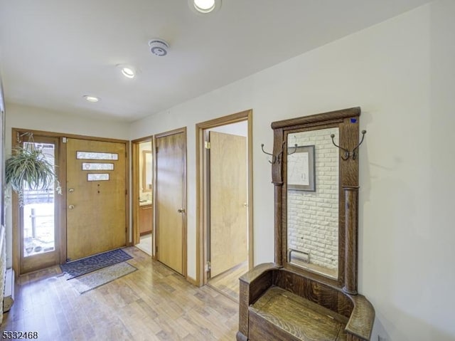 foyer entrance with light wood-type flooring and recessed lighting