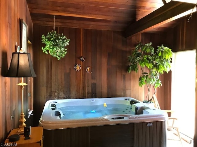 misc room with beamed ceiling, wood walls, wooden ceiling, and a hot tub