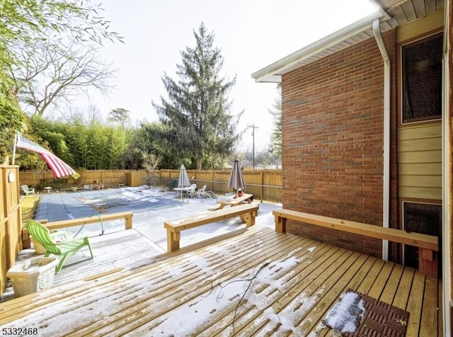 wooden terrace with a fenced backyard