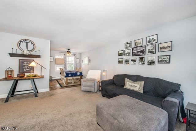 carpeted living room with ceiling fan