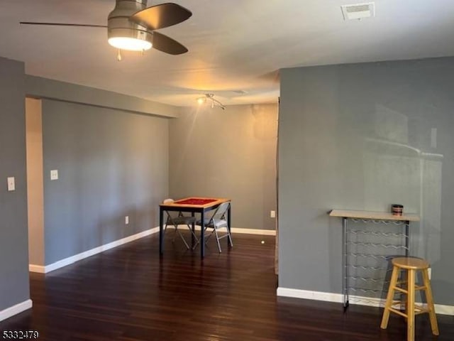 interior space featuring ceiling fan and dark hardwood / wood-style flooring