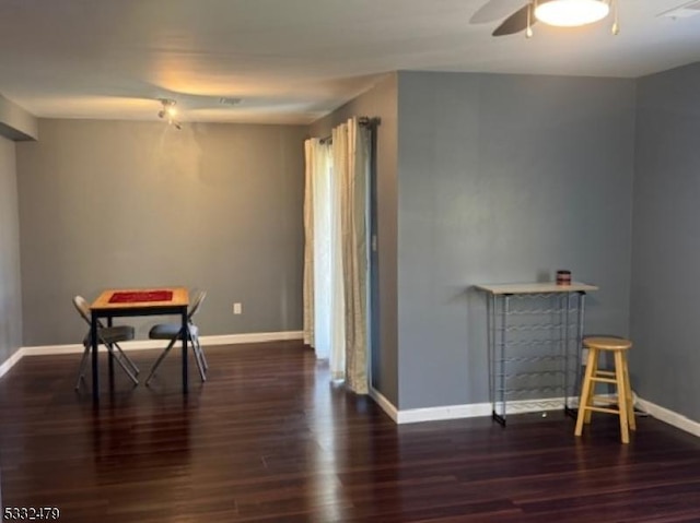 dining space featuring ceiling fan and dark hardwood / wood-style floors